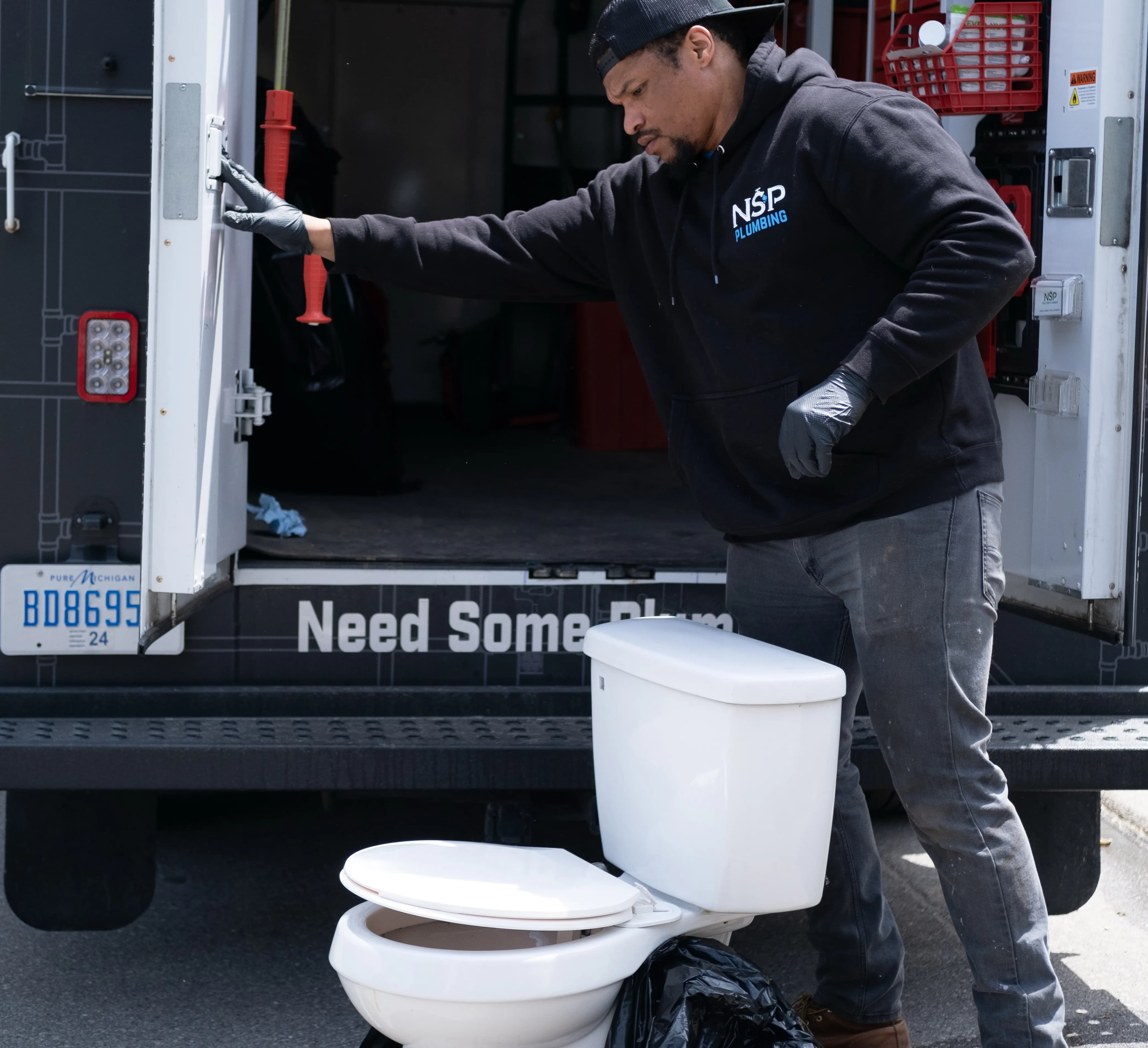NSP Plumbing licensed plumber repairing a fixture in a Grand Rapids, MI home